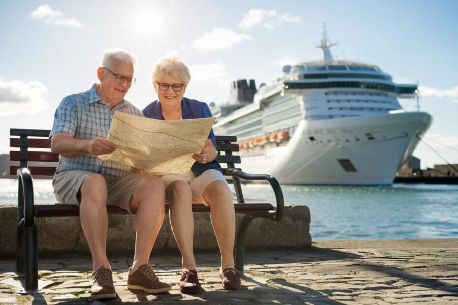 Couple reading a map in Port of Tyne, Newcastle on a sunny day with a cruise ship in the background