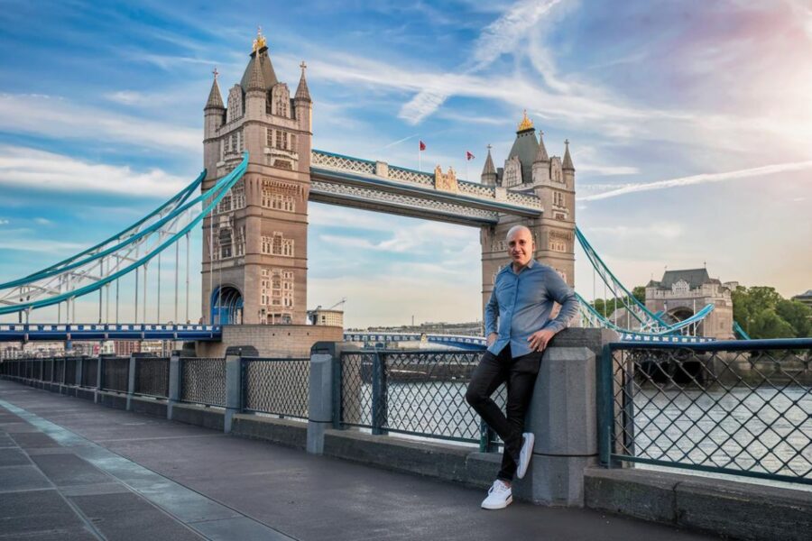 an adult man in casual clothes on Tower Bridge in london. Sunny day