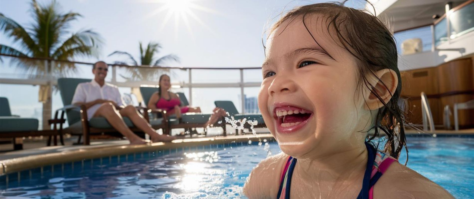 Happy girl in the pool on a family cruise ship