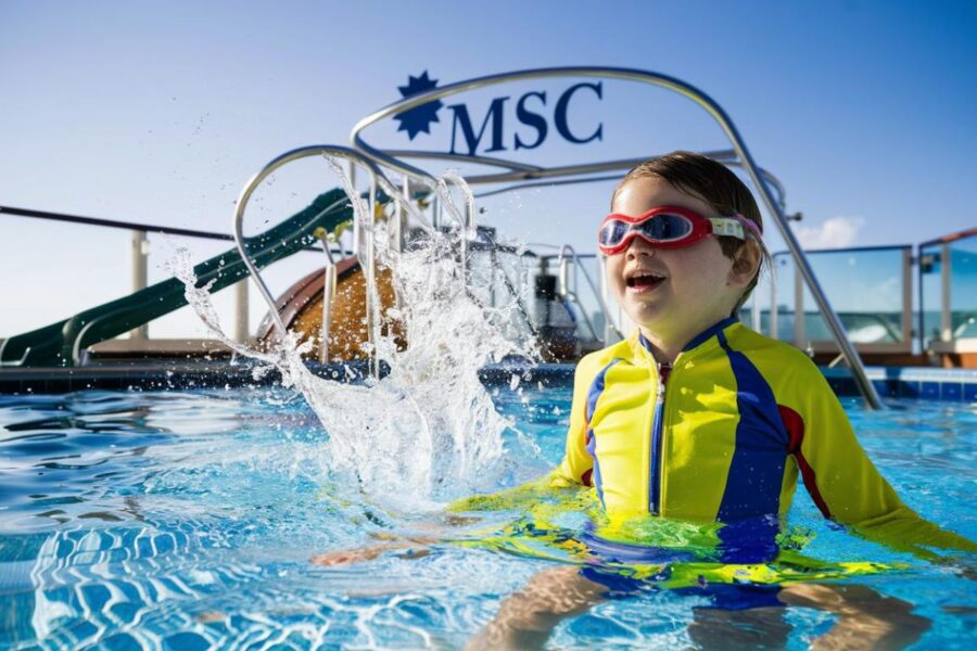 Happy kid in the swimming pool Water Park on MSC cruise ship