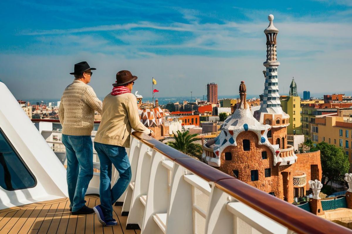 2 guests. dressed casually. looking out to the city. at the back of the cruise ship. with Barcelona, spain in the background. Sunny day.