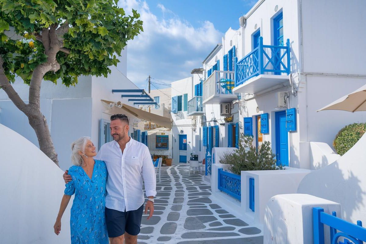 Couple wandering in Mykonos Town before cruising in the Mediterranean