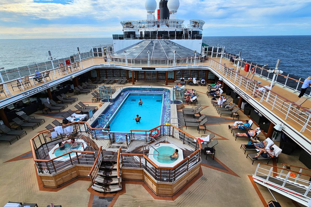 Looking down on the pool and hot tubs on Queen Elizabeth cruise ship