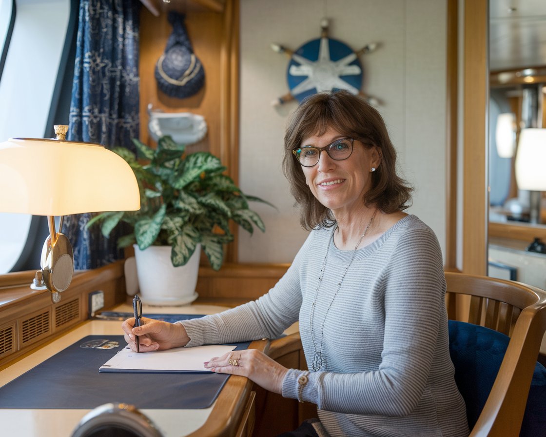 lady writing a review in her cabin on Norwegian Epic cruise ship