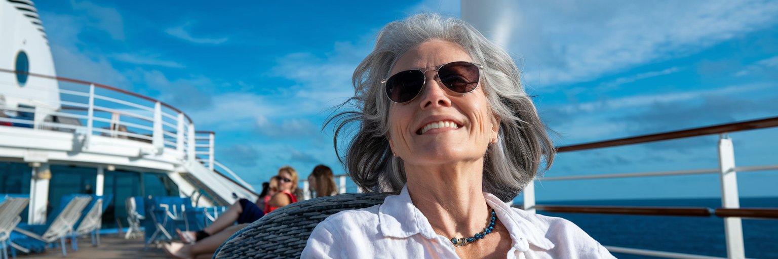 Single lady sunbathing on the deck of a cruise ship on a sunny day