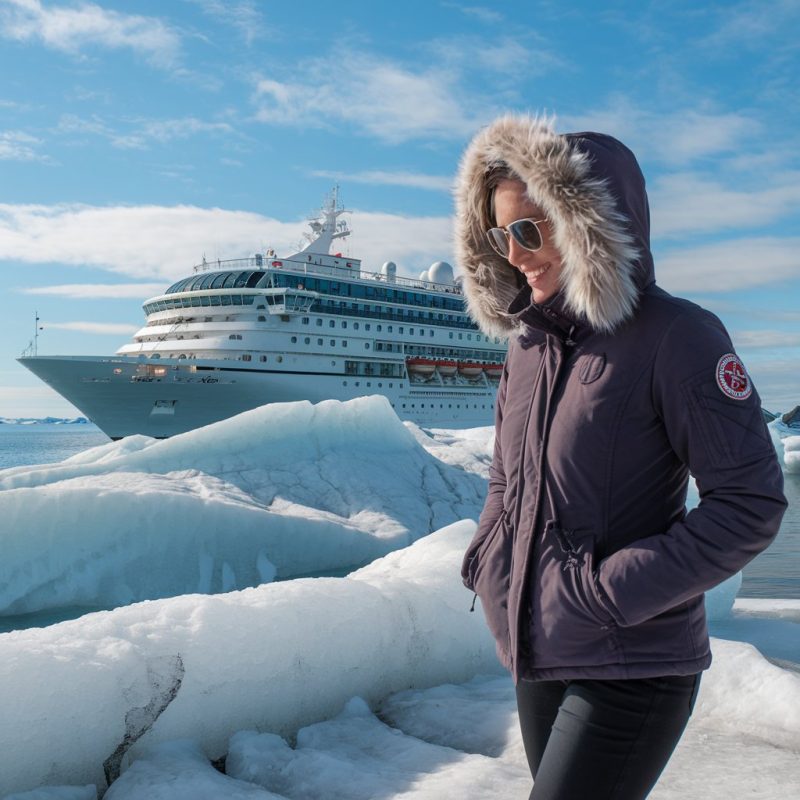 Jasmine French walking on an iceburg on a shore excursion from her polar expedition cruise ship