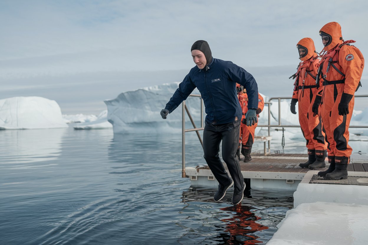 Man about to jump into freezing polar waters from his cruise ship