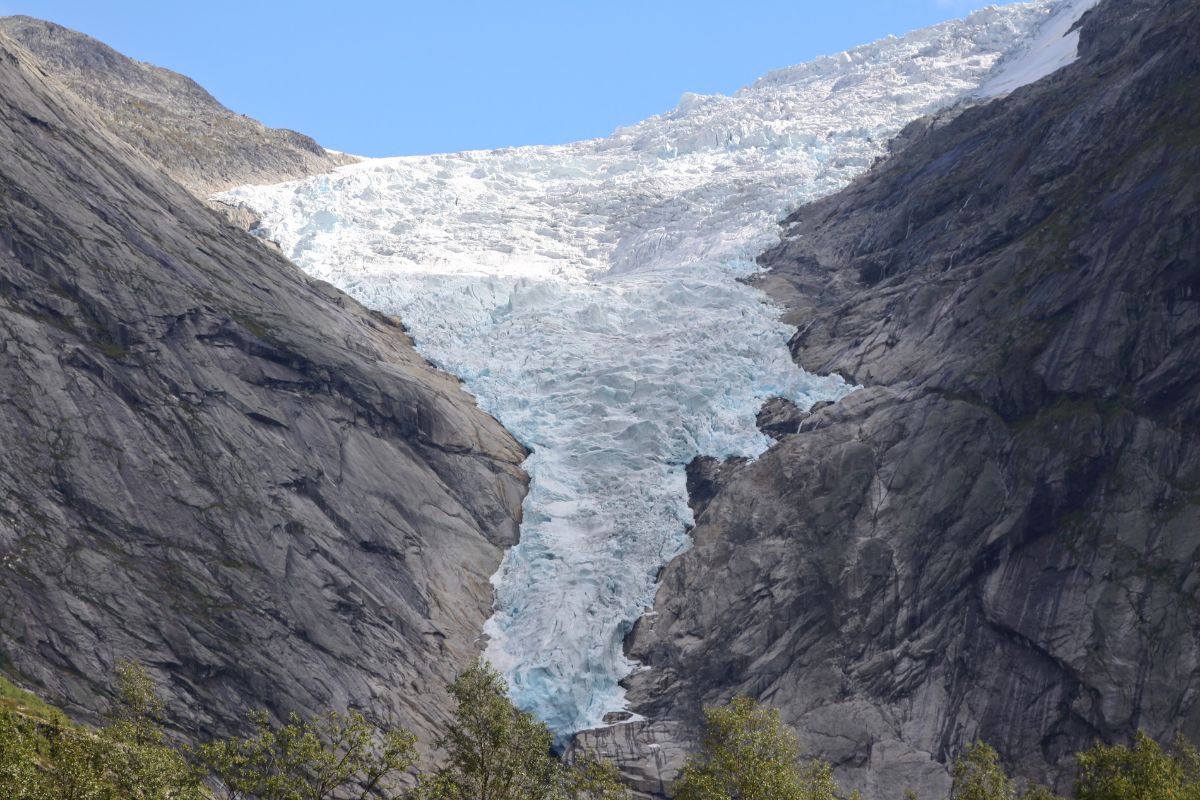 Briksdal Glacier cascading down between steep rocky mountains near Olden Norway cruise port