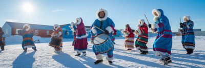 Several Inuit singing and playing the drums