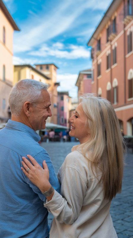 Older man and lady in walking shoes and shorts in La Spezia on a sunny day