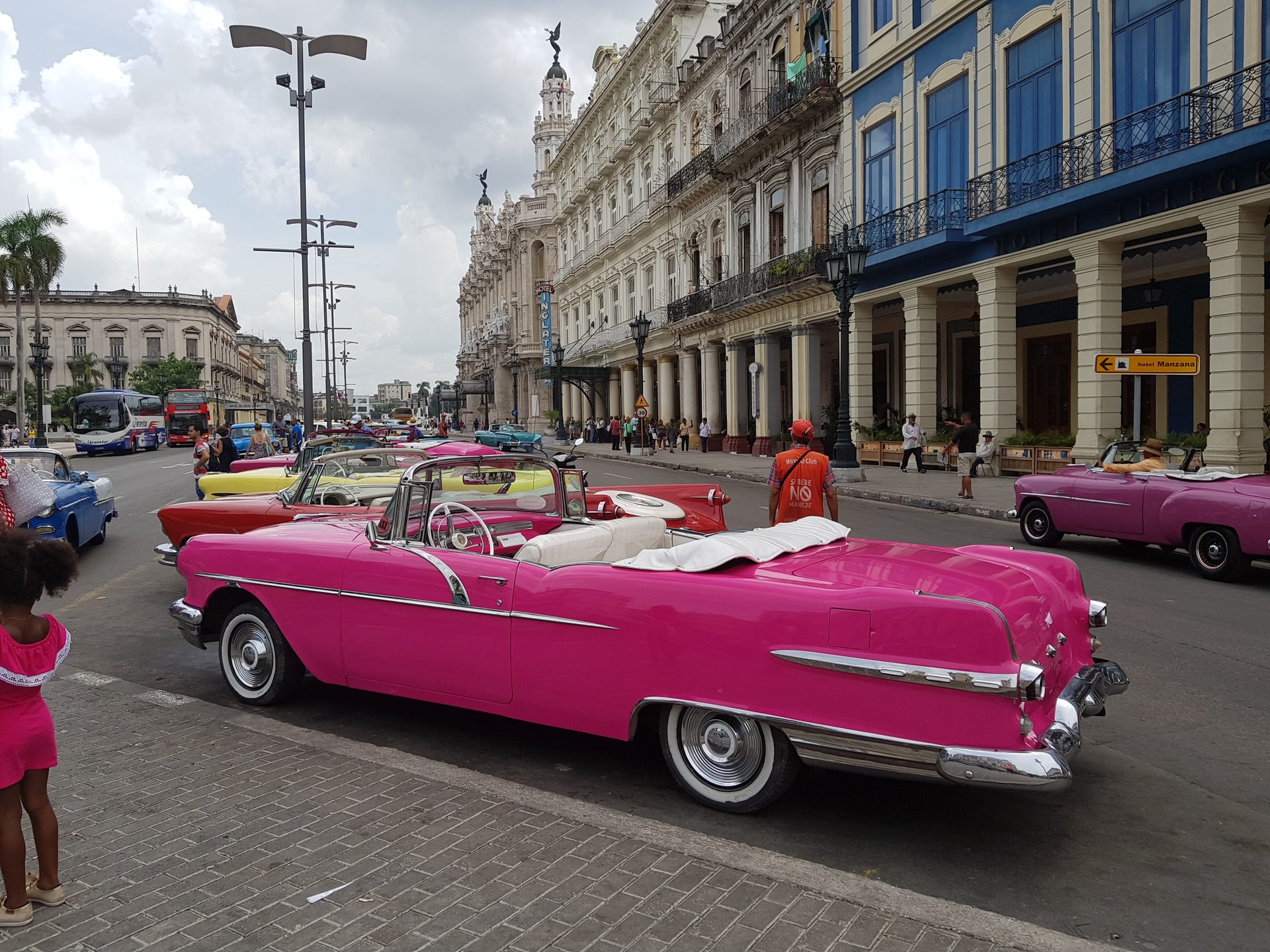 Pink 1950s Pontiac convertible taxi parked outside Hotel Inglaterra at Parque Central, Havana, Cuba