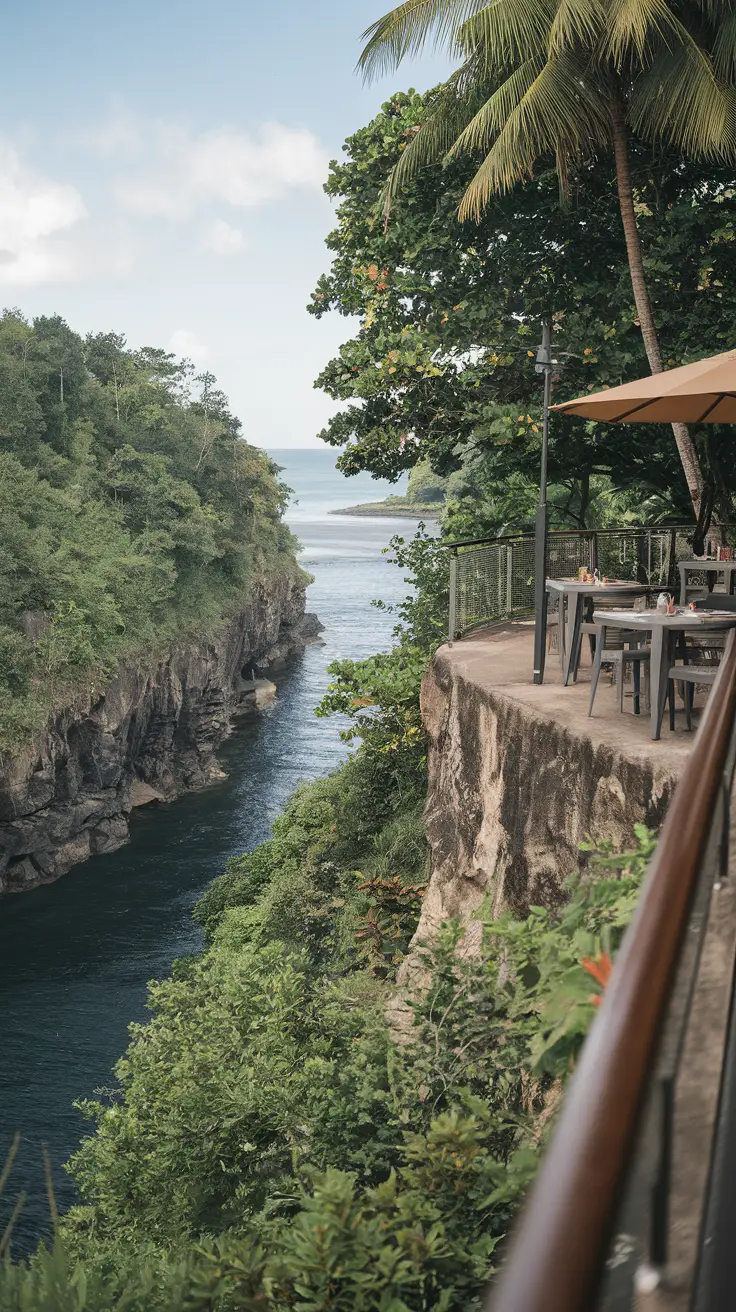 From the cliffside restaurant of this private cove, diners enjoy gorgeous vistas where the river meets the sea amid lush tropical surroundings.