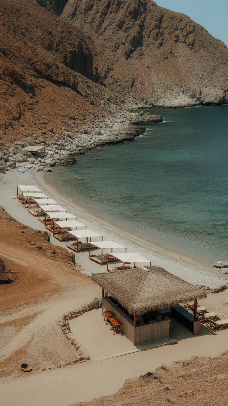A romantic, hidden cove reached by a rugged road, featuring a charming beach bar and rentable shaded beds—perfect for couples or solitude seekers.