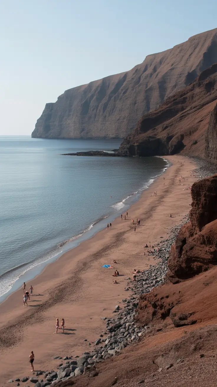 A secluded, natural beach with soft reddish-brown sand and volcanic cliffs, only 15 minutes from Fira, offering an unspoiled retreat and an unofficial naturist section.
