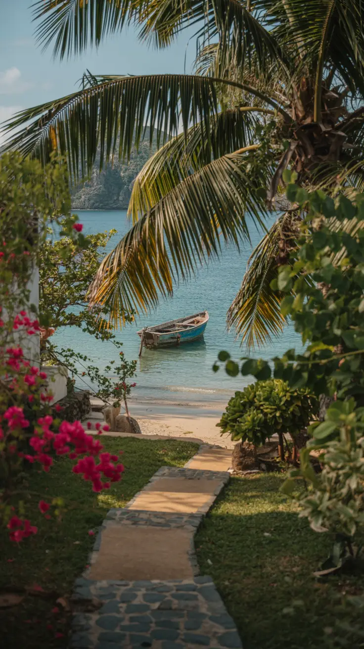 A narrow, sun-dappled cobblestone path winds through a lush tropical garden, bordered by vibrant bougainvillea and swaying palm fronds, leading toward a hidden beach cove glowing in the golden afternoon light with turquoise waters and a lone wooden fishing boat resting on the untouched white sand.