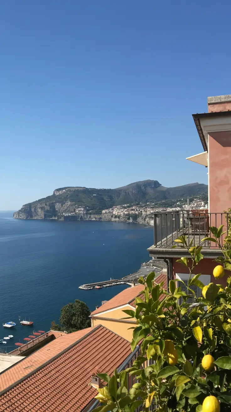 A crisp, sunlit view of Sorrento’s coastline taken from a cliffside terrace—cerulean sea stretching into the horizon, terracotta rooftops below, and lemon trees in the foreground glowing under the clear blue sky.