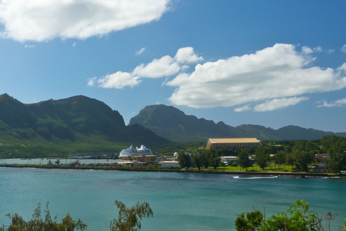 Cruise ship docked at Nawiliwili Harbor Kauai with green mountains in background