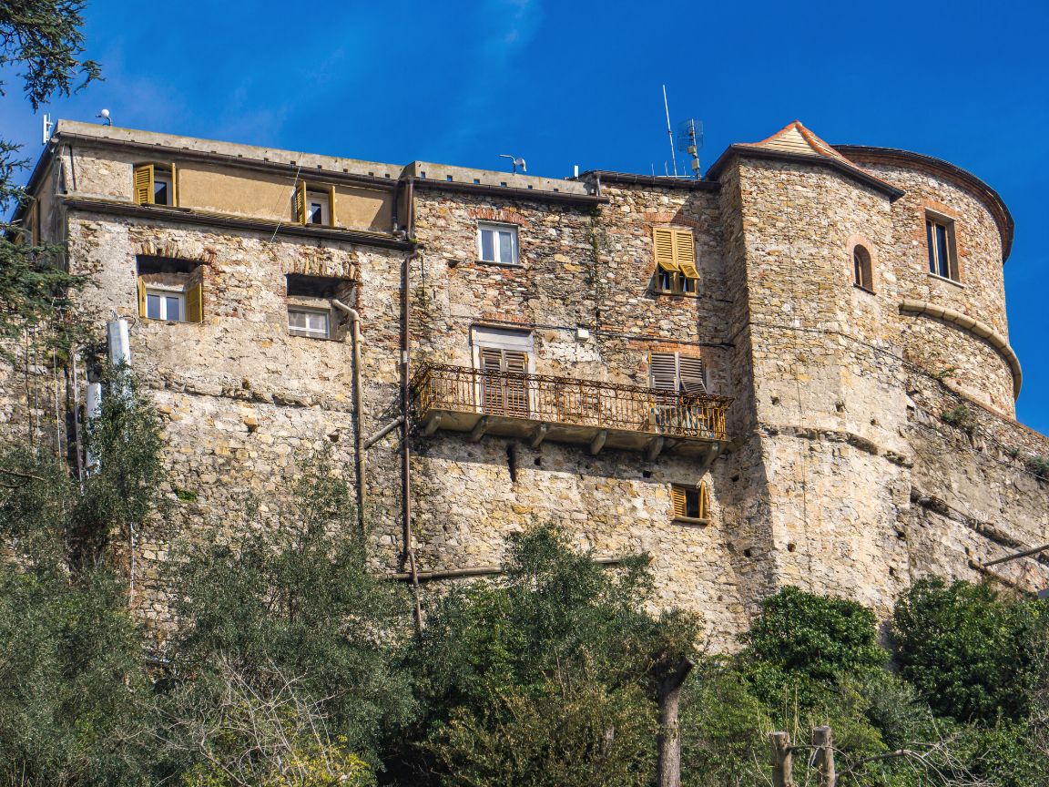 Castello Brown castle gardens overlooking Portofino harbor bay with cruise ship anchored and colorful village buildings Mediterranean sea views