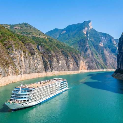 Large river cruise ship sailing through the dramatic Three Gorges on China's Yangtze River