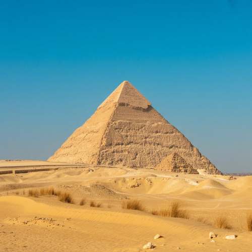 The Great Pyramid of Giza rising from the desert, Egypt