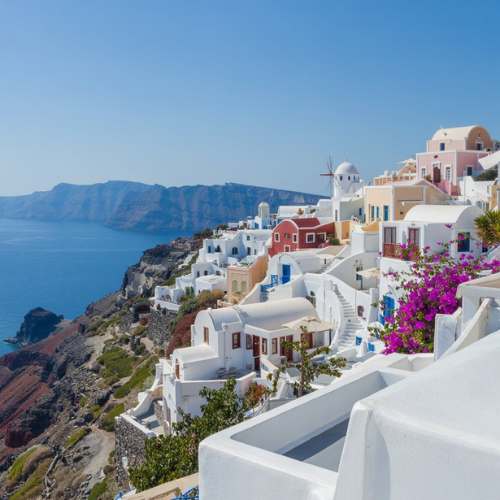 Santorini whitewashed houses and blue domes overlooking the Aegean Sea