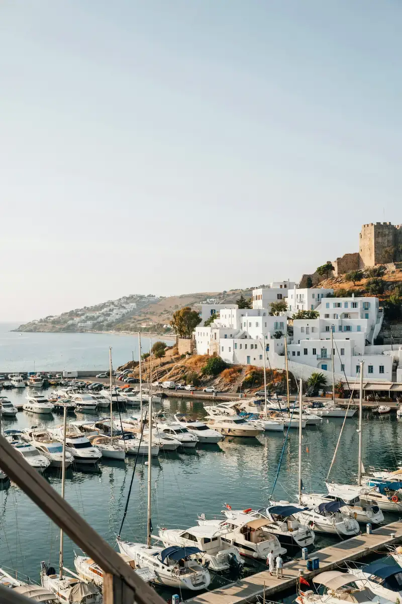 View of Bodrum harbour with whitewashed buildings lining the marina on a sunny day