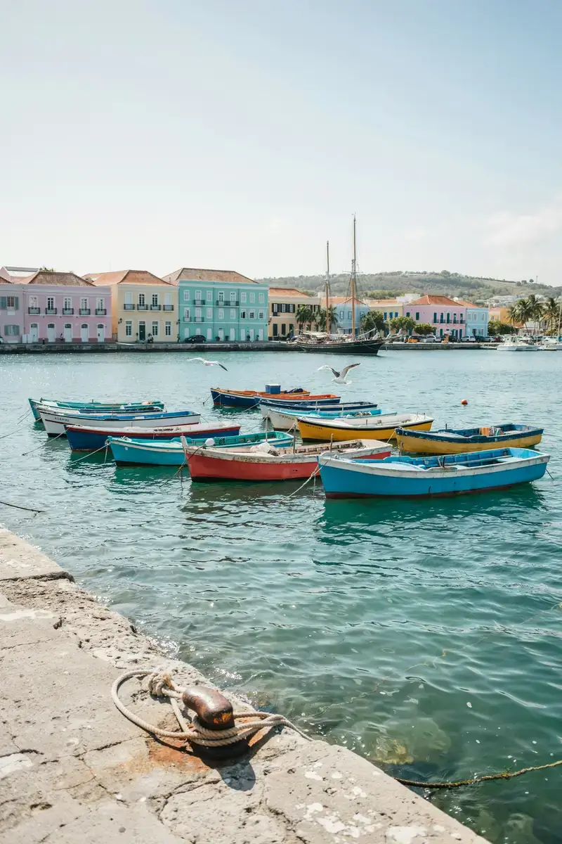 Bridgetown harbour lined with colourful boats and colonial-style buildings under a sunny sky
