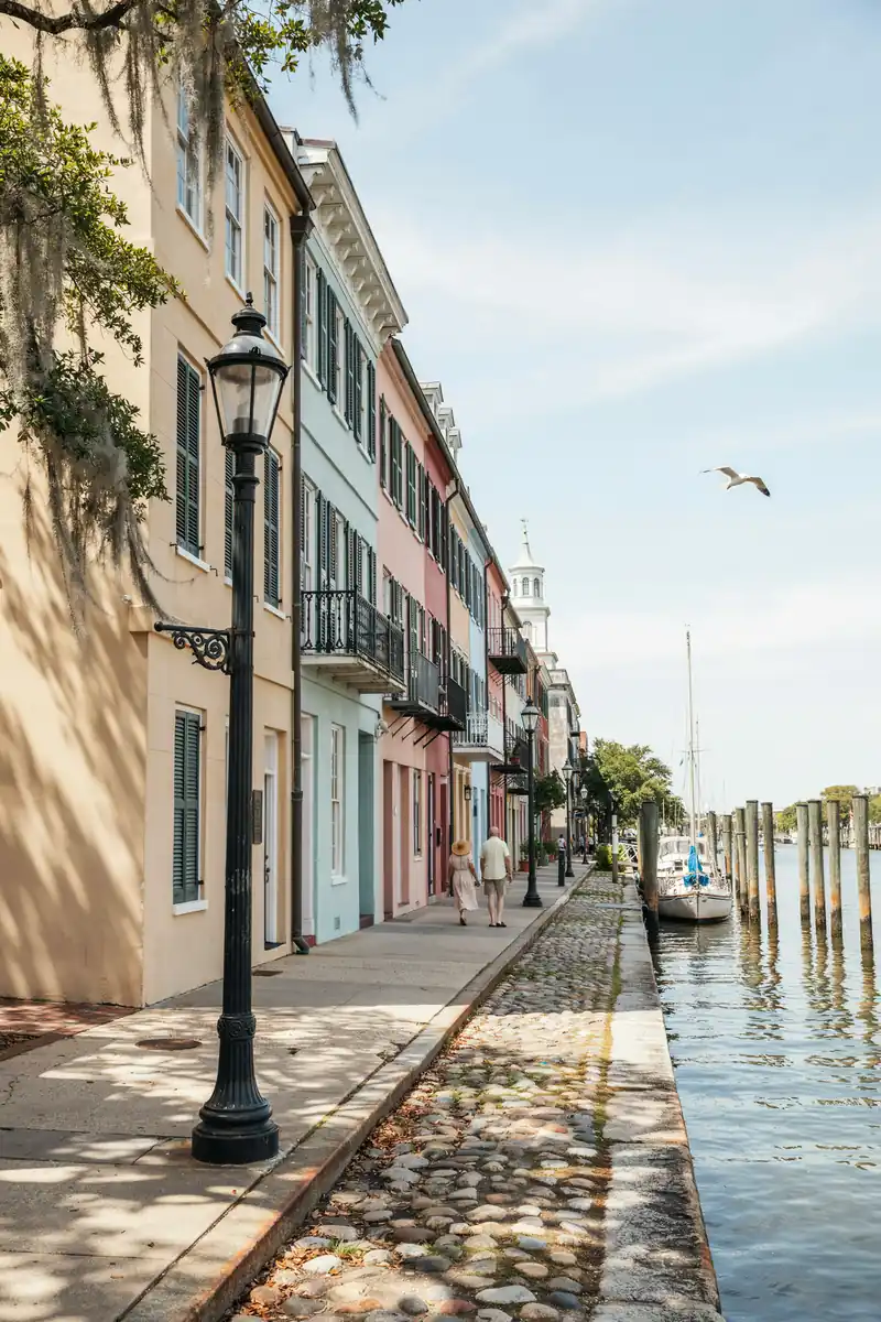 Charleston harbour waterfront lined with historic pastel-coloured buildings on a sunny day