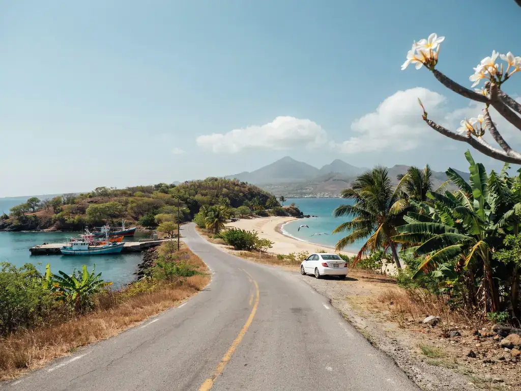 Winding coastal road connecting the cruise port to the beach in St. Kitts on a sunny day