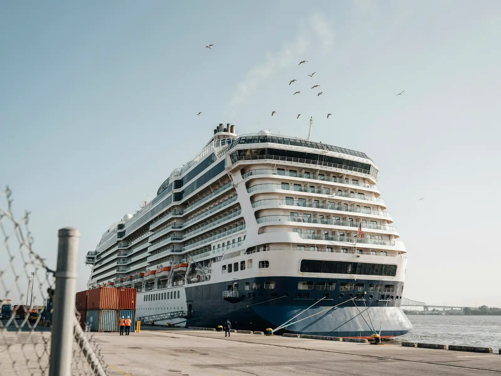 A cruise ship docked at the port terminal in New Orleans on a sunny day
