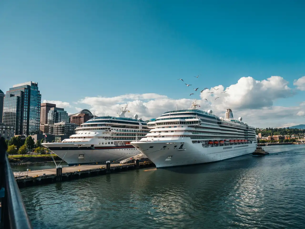 Cruise ships docked at a riverfront port in Portland, Oregon on a sunny day