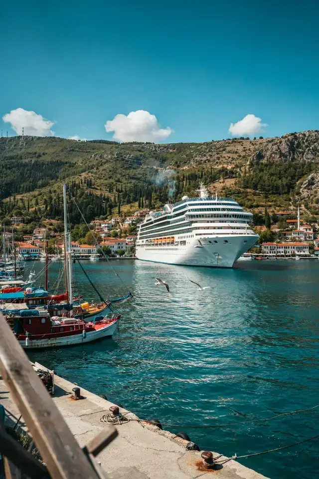 Fethiye harbour with a cruise ship anchored against a mountainous coastline