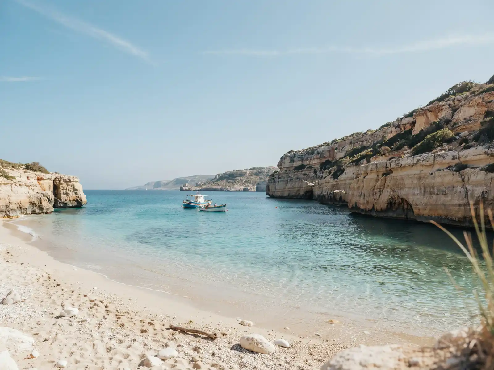 Turquoise sea, sandy beach and coastal cliffs in Formentera
