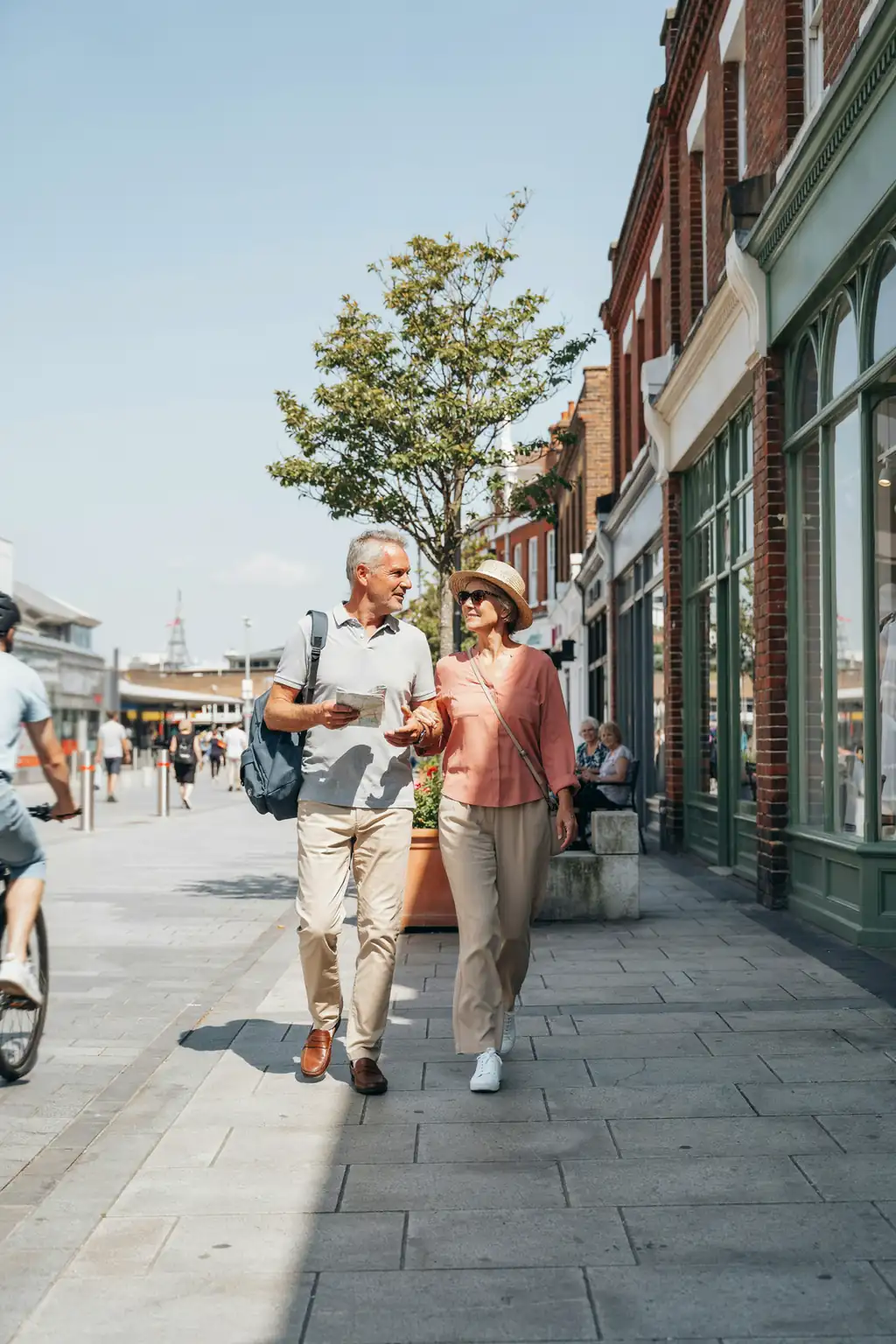 A group of older tourists walking together with luggage on a sunny day