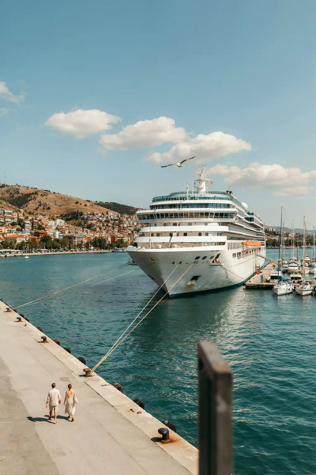 Sunny waterfront harbour in Izmir with a cruise ship docked at the port