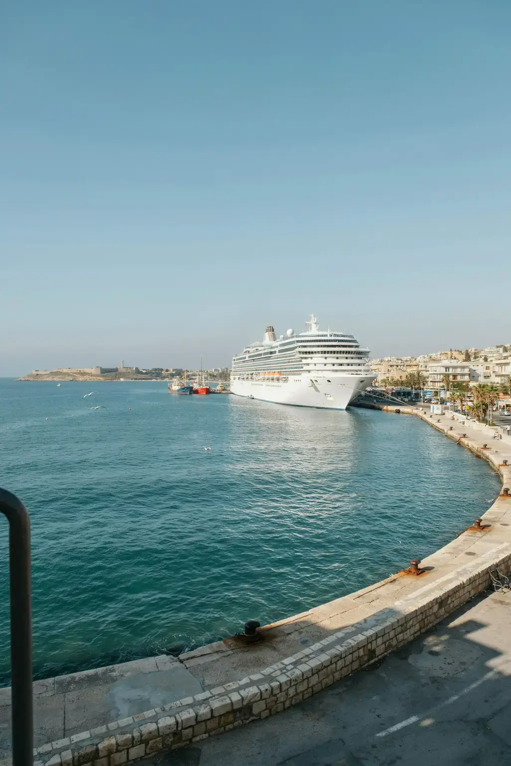 Limassol harbour with a cruise ship docked against the Cyprus coastline