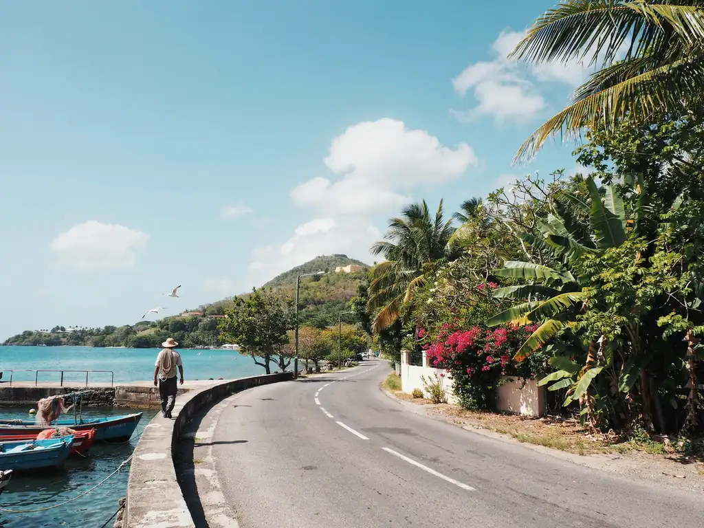 Coastal road leading towards Pigeon Island in St Lucia on a sunny day