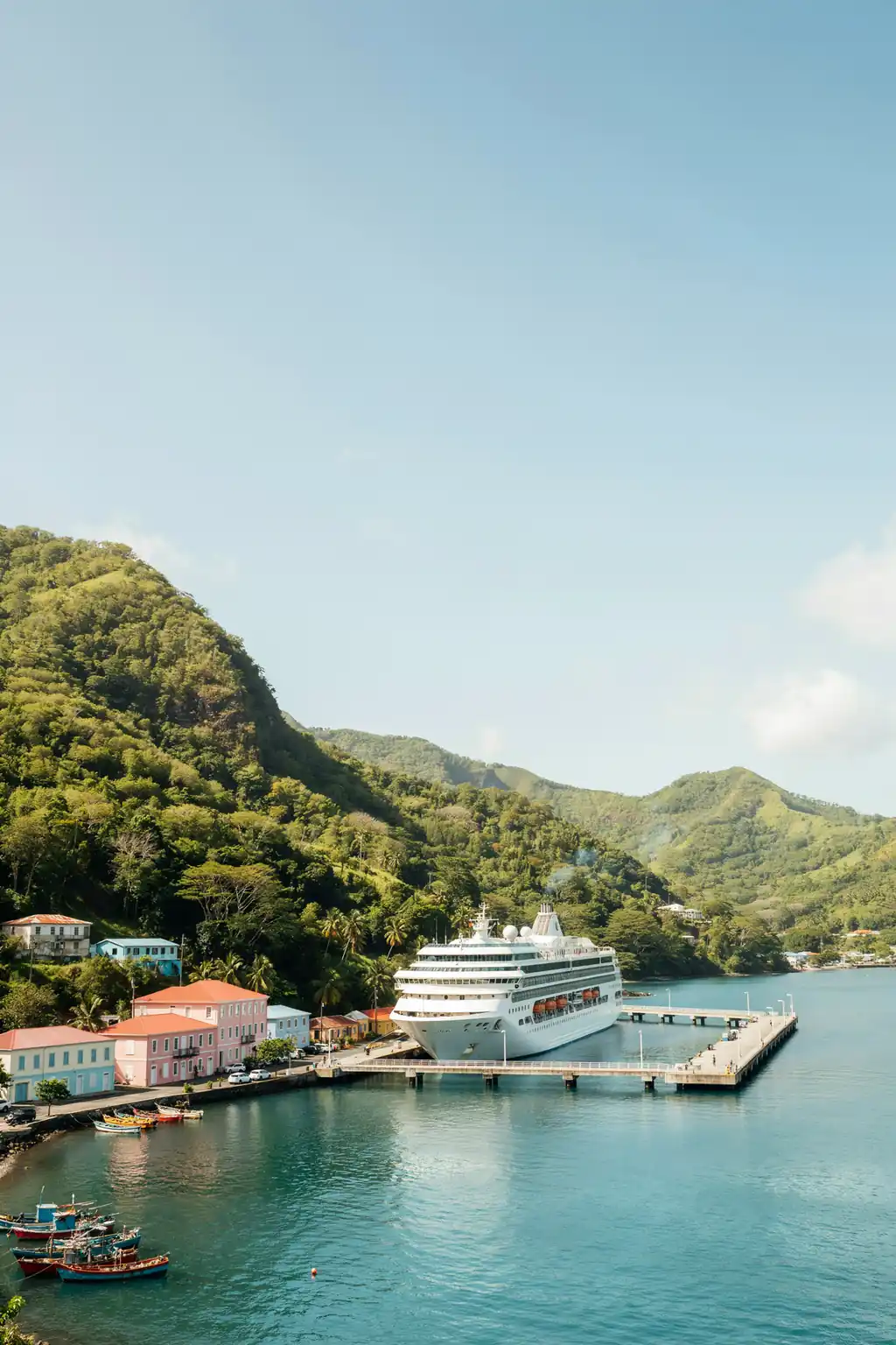 Waterfront harbour in Roseau, Dominica with a cruise ship pier and colourful buildings along the shore