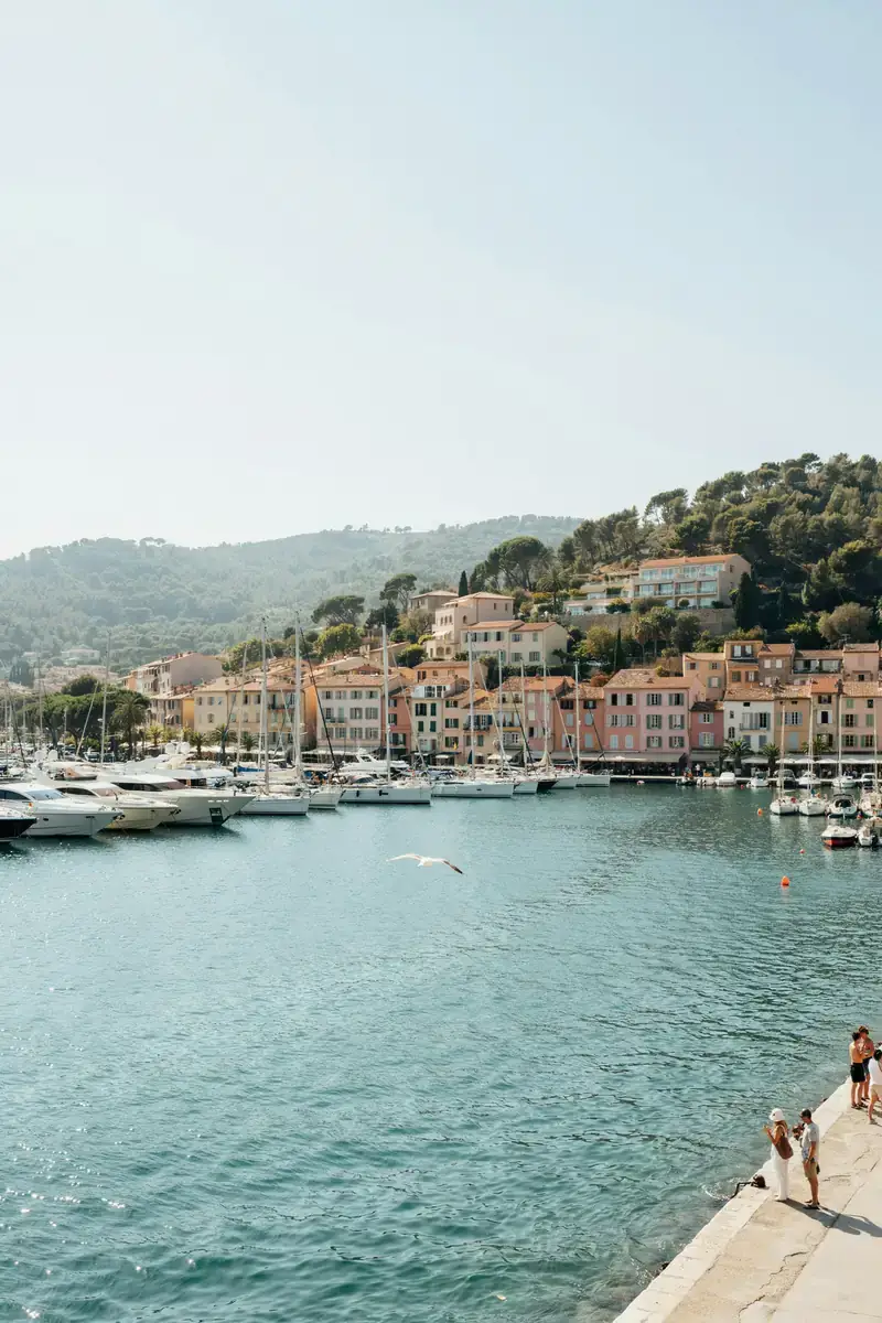 St. Tropez harbour lined with yachts and pastel-coloured buildings