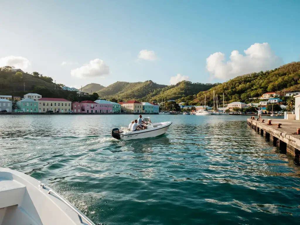 A tender boat approaching the harbour at Charlestown, Nevis, on a sunny day
