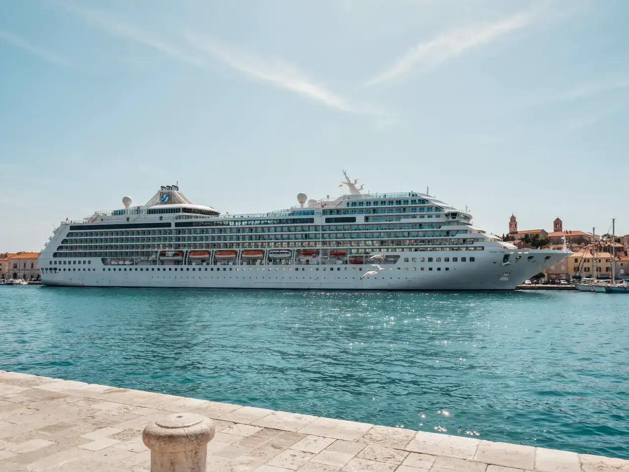 Two cruise ships docked together in Zadar harbour on a sunny day