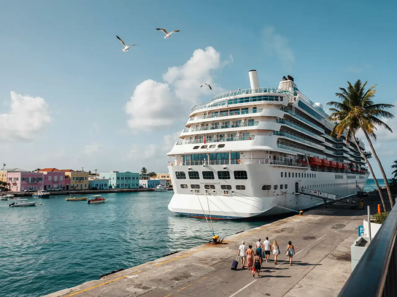 A cruise ship docked alongside a pier in Aruba on a sunny day