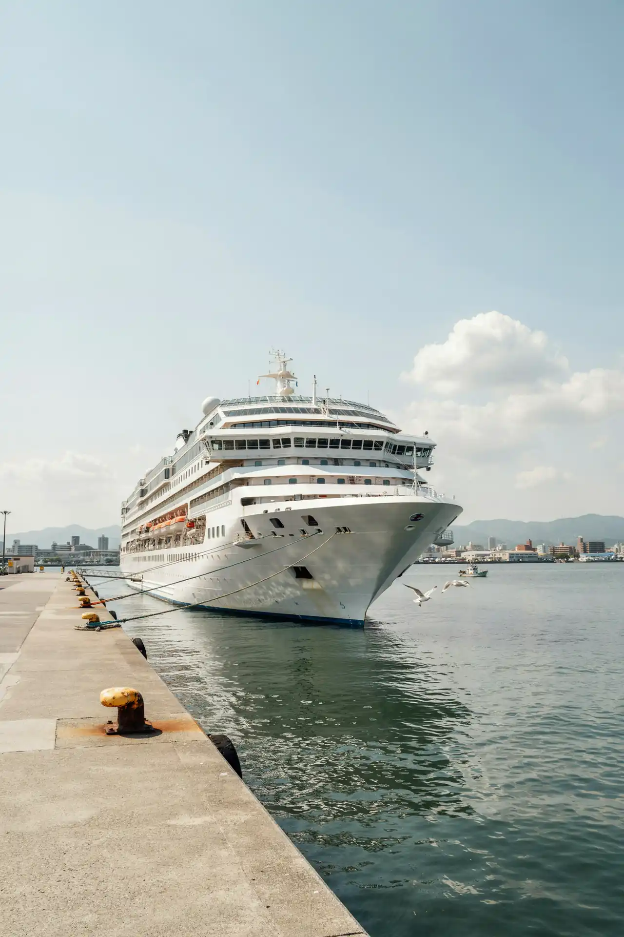 A cruise ship docked at the port of Hiroshima on a sunny day