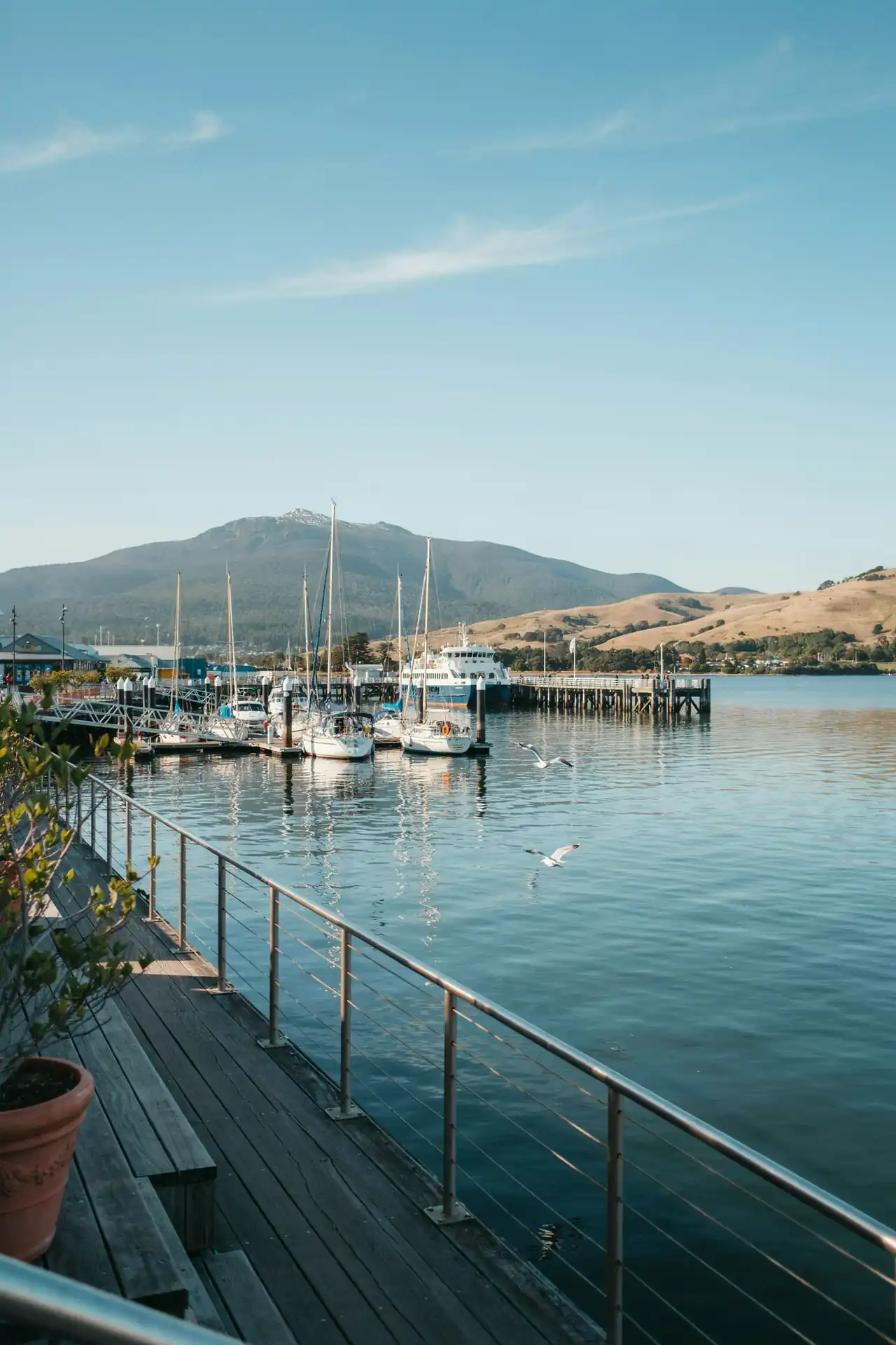 Hobart harbour waterfront with boats and hills in the background