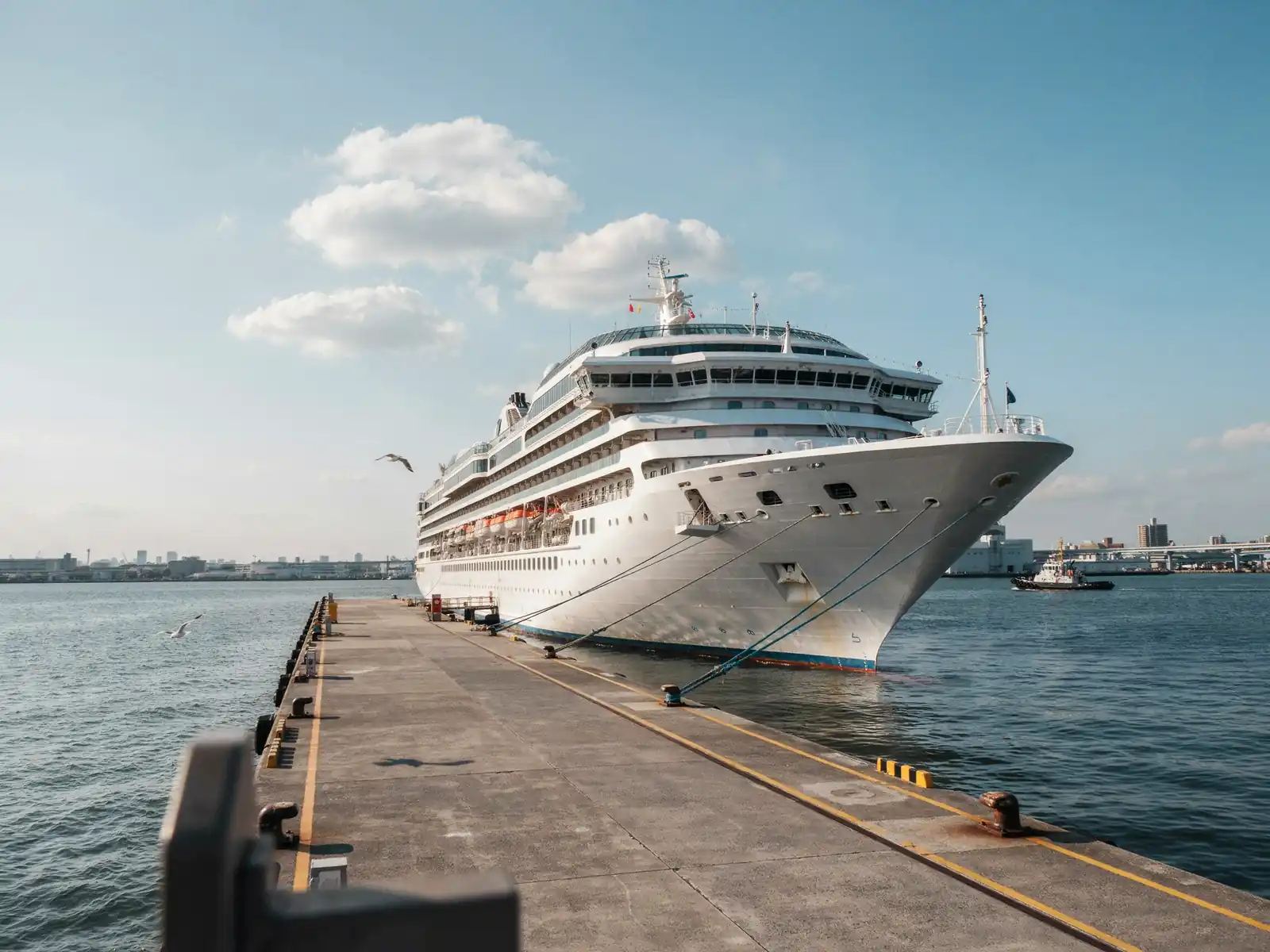 Large cruise ship docked at Itsukaichi Wharf berth in Hiroshima under a sunny sky