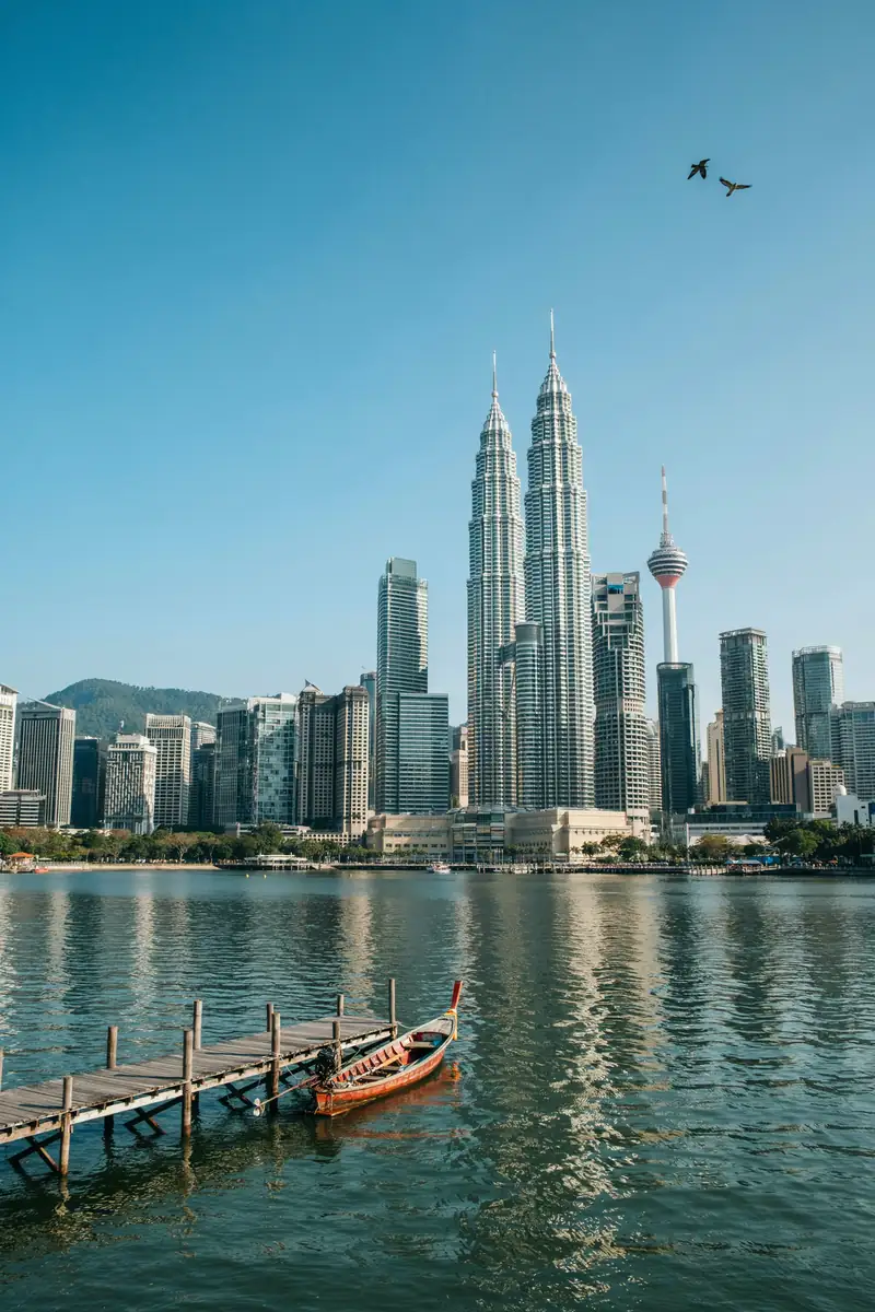 Kuala Lumpur city skyline with twin towers viewed from the harbour on a sunny day