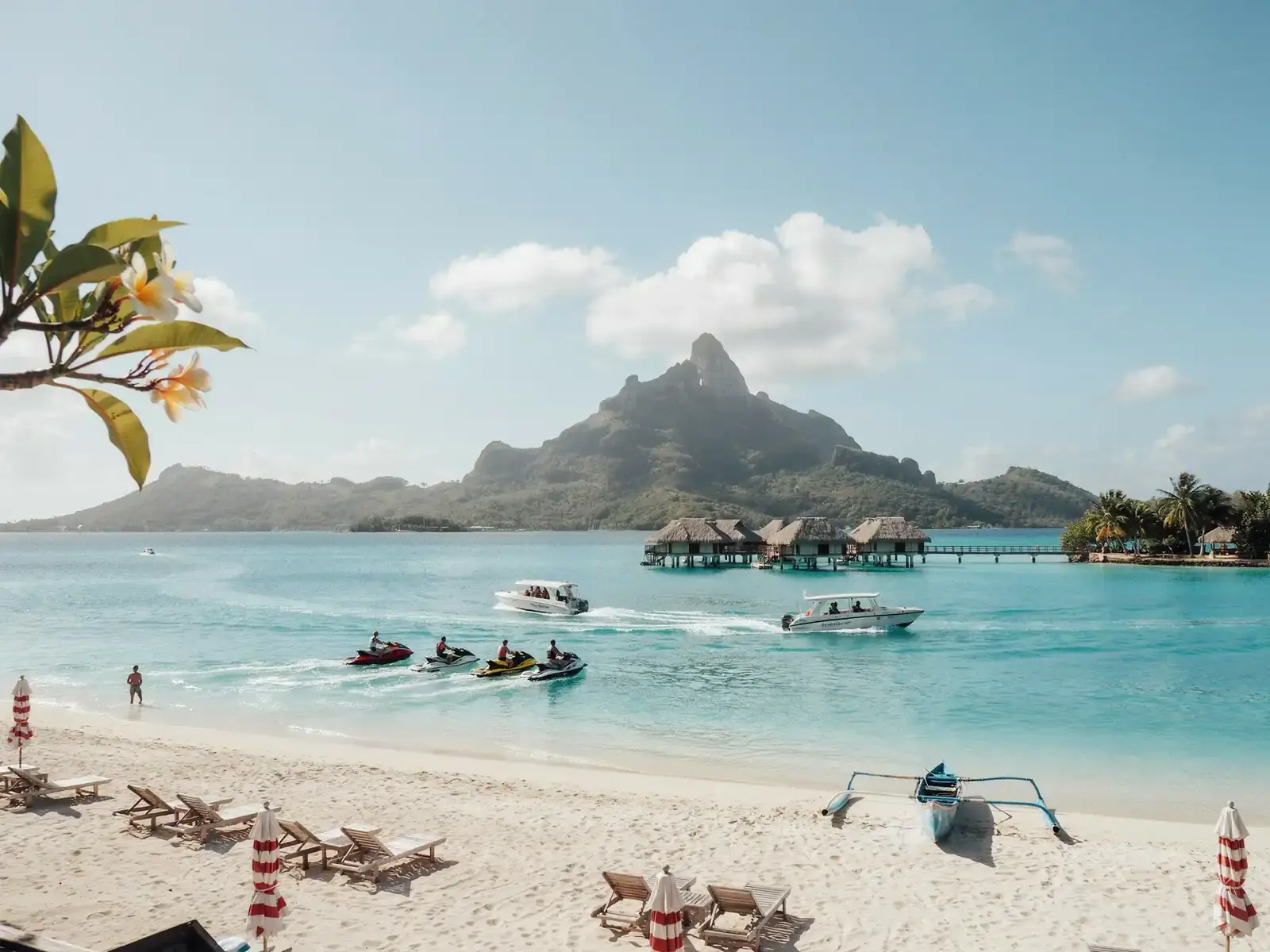 Lagoon taxi boats and scooters along the shoreline of Bora Bora
