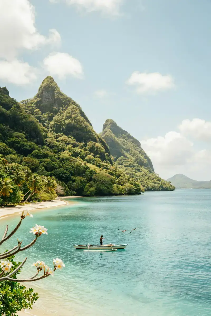 Moorea harbour with dramatic green mountain peaks under a sunny sky