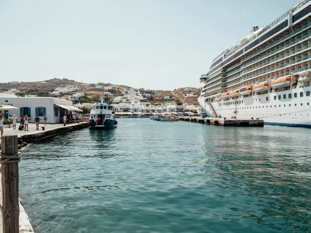 Side-by-side view of Mykonos ferry port and cruise port harbours on a sunny day
