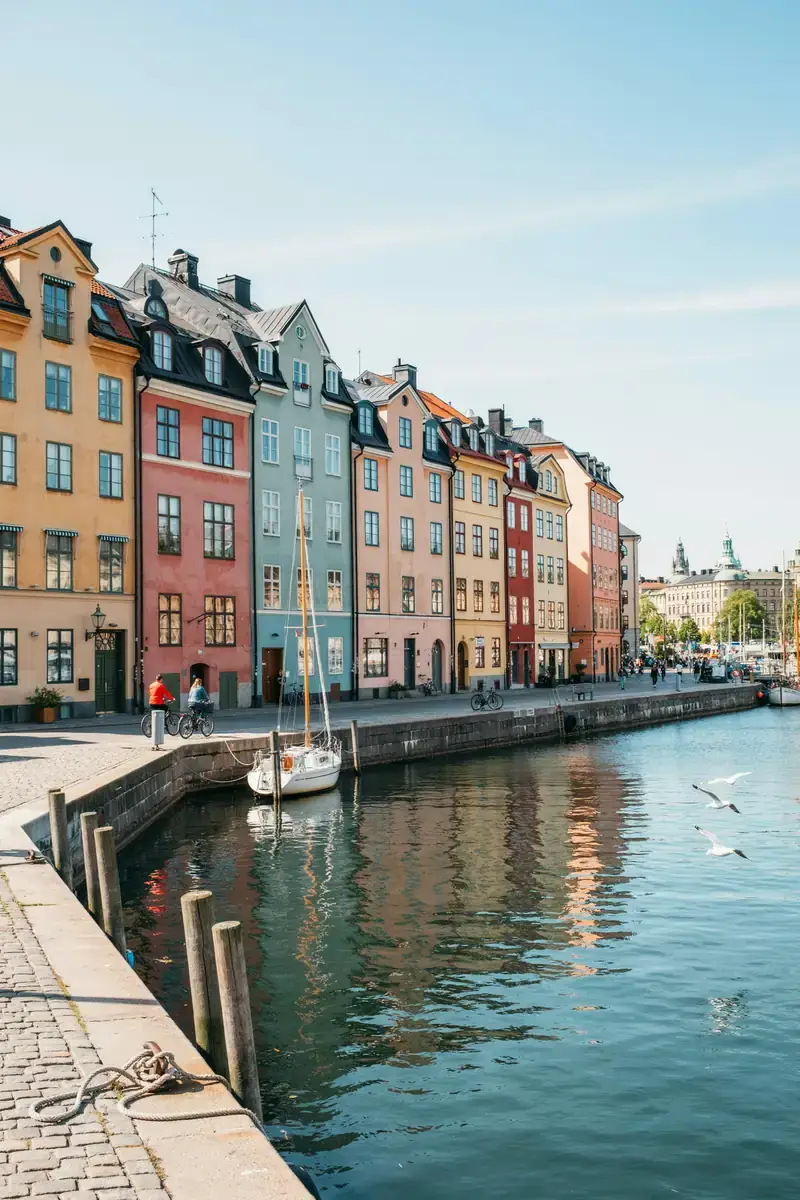 Stockholm harbour lined with colourful waterfront buildings on a sunny day